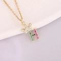 Macro view of 18K gold crown and 'H' pendant with colorful zircon stones - Letter H Style