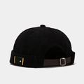 Black corduroy docker cap with brown leather strap and metallic buckle adjustment - Black
