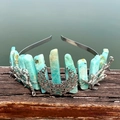 Detailed view of turquoise crystal moon crown with silver branch ornaments on wood - Amazonite