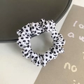 Elastic fabric scrunchie featuring a classic white and black polka dot pattern design - White Polka Dot