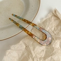 Elegant U-shaped acetate hair fork in blue amber tortoiseshell pattern with French text - Faux Acetate Lake Blue Brown