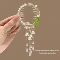 Detail of Lily of the Valley hair claw with golden tassels and dimensions of 6.5cm diameter - Star Lily of the Valley Tassel