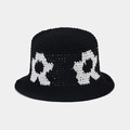 Close-up of handmade crochet bucket hat with floral knit pattern in black and white - One Size / Black