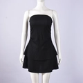 Close-up of black strapless mini dress featuring textured pleated fabric and layered ruffles - S / Black