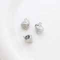 Macro detail of three silver conch shell pendants for DIY jewelry on white surface - 14# Silver Spiraled Conch