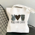 White canvas tote bag with Peace Love Coffee graphic on a black metal chair - Leopard Coffee Pattern Style (B100303-TBWH-M)