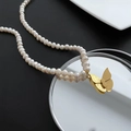 Elegant baroque pearl necklace featuring a golden butterfly pendant on a mirrored tray - 03-C15 Butterfly Natural Pearl Necklace