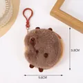 Plush brown capybara coin purse and keychain pendant with hook on white table - Sleeping Capybara