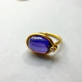 Detailed view of 18K gold plated ring featuring a large oval purple zircon gemstone - US 6 / Violet Blue