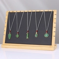 Bamboo jewelry stand featuring five green jade-style pendants with white woven cords - ZM009 Large Black PU Leather