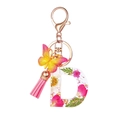 Portachiavi lettera D in resina con fiori rosa, farfalla e nappa rosa decorativa - Motivo Floreale D