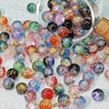 Mix of 10mm frosted glass beads with gold foil design spilling from a glass jar - Double Color Mix