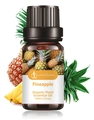 Organic pineapple essential oil in 10ml amber glass bottle with fresh pineapple background - Pineapple Aromatherapy