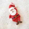 Detail of plush Santa Claus ornament with red felt suit and gold belt buckle hanging - Classic Santa Claus
