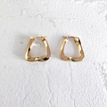Primer plano detallado de pendientes geométricos dorados sobre superficie blanca - Pequeño / Dorado