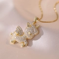 Golden unicorn pendant necklace with sparkling cubic zirconia on pink silk background - Gold Unicorn Necklace / Large
