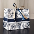Floral gift bag with blue butterfly prints and elegant ribbon bow on dark wood surface - Small / Floral Blue Waist (Gold & Navy Ribbon)