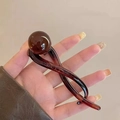 Pince à cheveux vintage française en résine ambre foncé avec un design torsadé élégant - Pince Torsadée Perle Teintée / Ambre