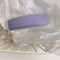 Close-up of a purple padded headband with twill texture inside a white storage basket - Light Purple