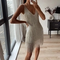 Detailed view of shimmering silver sequins and fringe on a V-neck party dress - S / White