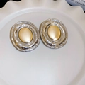 Detailed view of two-tone oval earrings with gold matte center and silver wavy texture - 21# Large Hoop