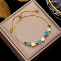 Elegant gold titanium steel bracelet with blue crystals and opal beads on jewelry box - Gold 9-Stone Blue White Black Bolo