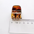 Macro view of 2cm amber tortoiseshell hair claw clip with size ruler measurement - 2.2cm / Tortoise
