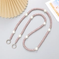 Elegant phone cross-body chain with pink rhinestones, pearls and metal links on a gray background - Rhinestone Ring Crossbody Chain / Pink