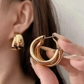 Exaggerated golden C-shaped triple hoop earrings with a shiny metallic mirror finish - Clip-on Earrings / Gold