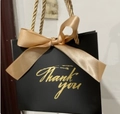Elegant black paper gift bag with gold rope handles and a large gold ribbon bow - 14*6*12cm / Black