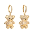Detaillierte Makroansicht der goldenen Teddybär-Creolen mit funkelnden weißen Zirkonia - Goldene Bärenohrringe mit Weißem Zirkonia