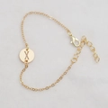 Golden round hollow bracelet featuring initial letter X with adjustable lobster clasp - Gold X