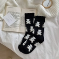 Warm black coral fleece socks with white bear patterns on a cozy white blanket - One Size / Black