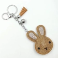 Sparkling rabbit head keychain with brown tassel and gold rhinestones on white background - Khaki