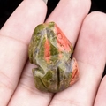 Natural Unakite frog figurine miniature carving displayed in hand for size reference - Unakite