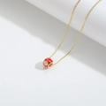 Golden necklace featuring a red doughnut pendant with evil eye and star motifs - Red Evil Eye