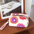 Plush floral makeup bag with purple and orange flower patterns and pink handle - Handheld White With Floral Print
