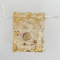 Detail of sheer organza gift bag with gold stars pattern and white ribbon drawstring - Gold Star