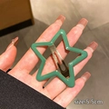 Close-up of a 5.5cm green star-shaped hair clip with a glossy metallic finish - 5.5cm / Green