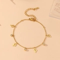 Macro shot of 18k gold plated music note bracelet with clear cubic zirconia charms - Music Note Charm (K602)
