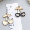 Black enamel cherry pendant with rhinestones and gold metal back showing size scale - White Stone Cherry (23404)