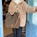 Macro shot of fluffy striped plush tote bag with logo label and durable canvas strap - Brown Stripes