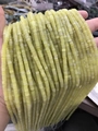 Strand of 2x4mm pale yellow stone tube spacer beads for DIY jewelry making held in hand - Lemon Jade