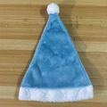 Blue and white plush Christmas hat with a fluffy pom-pom on a wooden background - Sky Blue