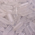 Close-up of double-pointed clear crystal hexagonal pillars in a dense pile - White Crystal
