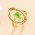 Gold stainless steel oval ring featuring a real green dried flower in resin - Gold with Green Flower