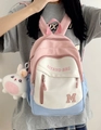 Girl wearing a tricolor patchwork school backpack with a cute white rabbit pendant - Single Bag / Pink