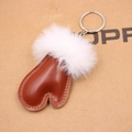 Detail of brown heart leather keychain with white fur ball and metal ring accessory - Brown