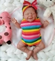 20 inch sleeping reborn baby doll in rainbow stripe outfit and headband on white rug - Rainbow Stripe Style / Normal Painted Cloth Body