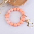 Detail of pink silicone bead keychain with 3D rose charm and golden metal clasp on white base - Hot Pink Rose